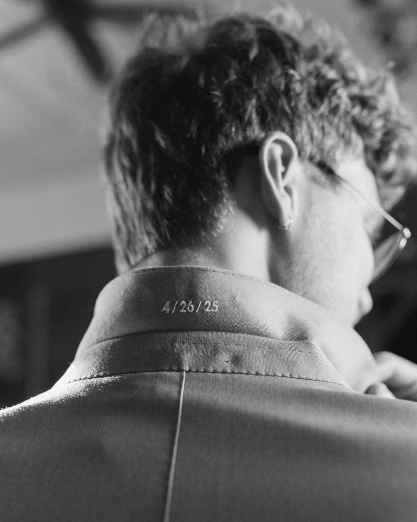 A black and white close up image of a wedding date embroidered onto a groom's collar at this Vashon wedding 