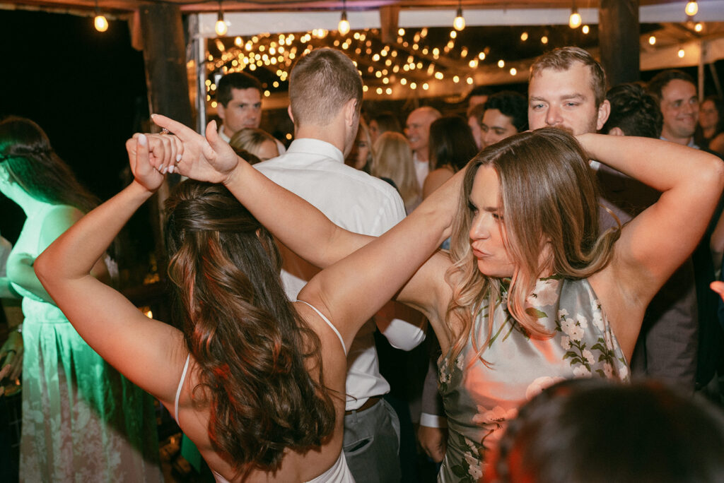 A Washington bride shares a dance with a guest at her Whidbey Island wedding reception 