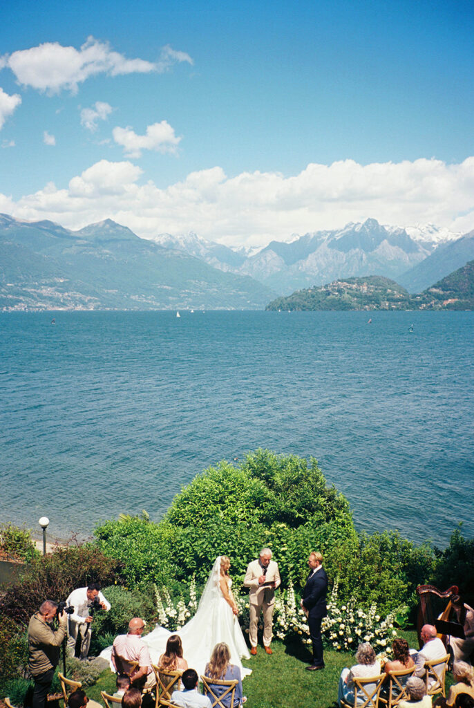 A scenic waterfront wedding ceremony is shown at Villa la Felice 