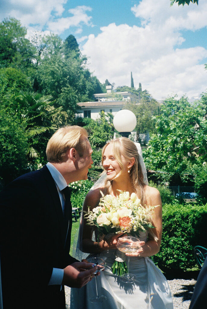A bride & groom exchange smiles on their wedding day in an image taken by destination wedding photographer, Mossfloor Photography