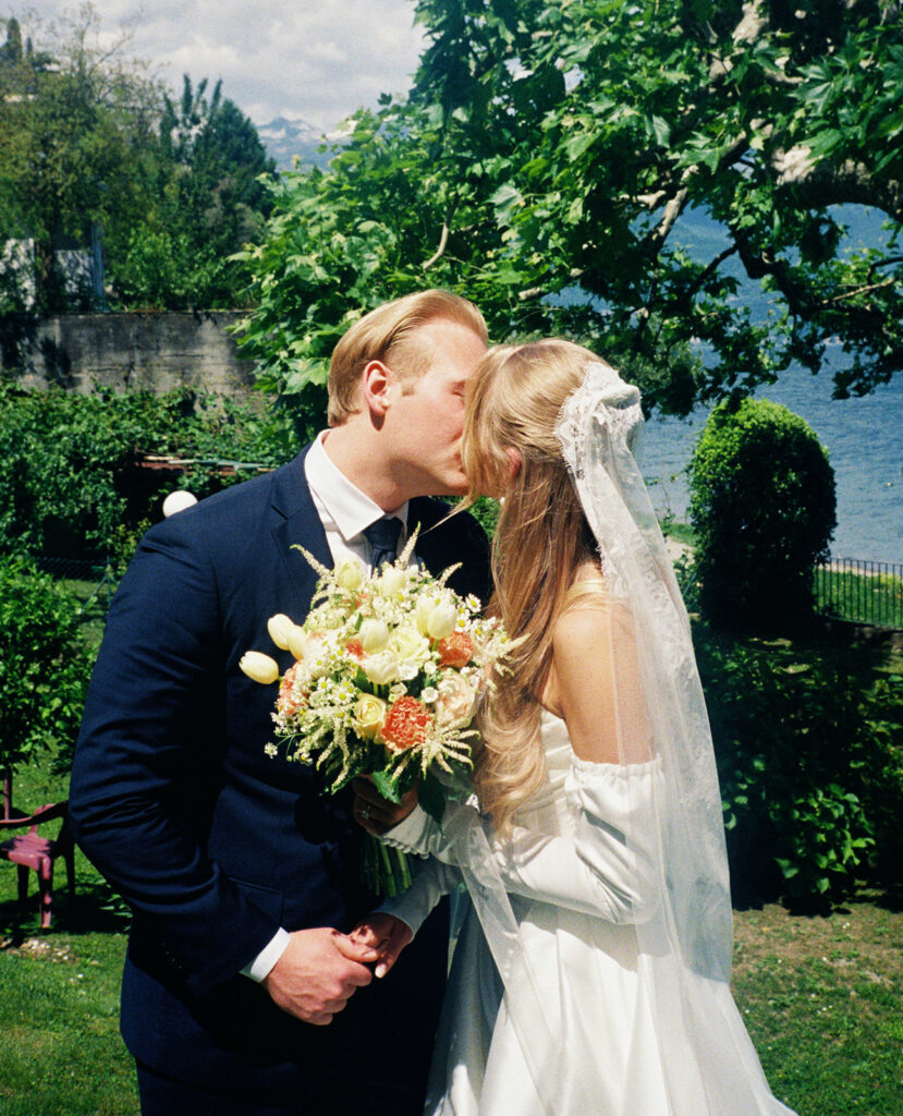 Newlyweds share a kiss at their destination wedding lake como 