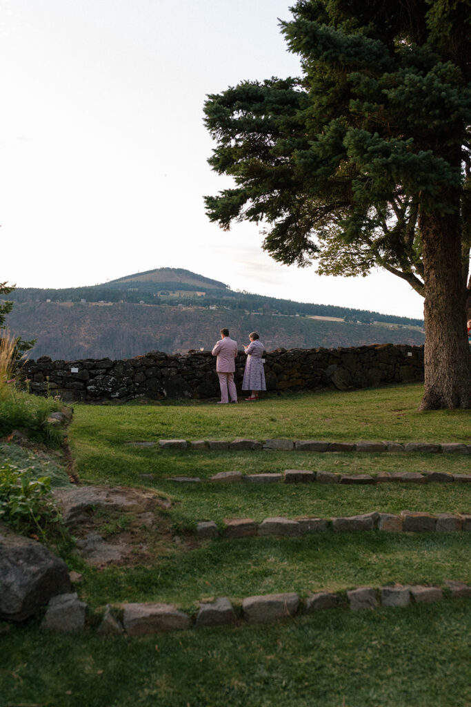 Guests take in the view of the Columbia River Gorge from a wedding at the griffin house hood river