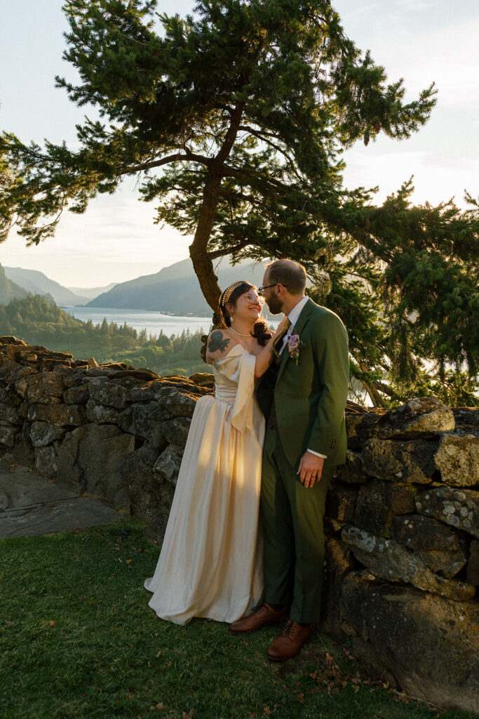 Newlyweds pose for bridal portraits at golden hour at their griffin house hood river wedding