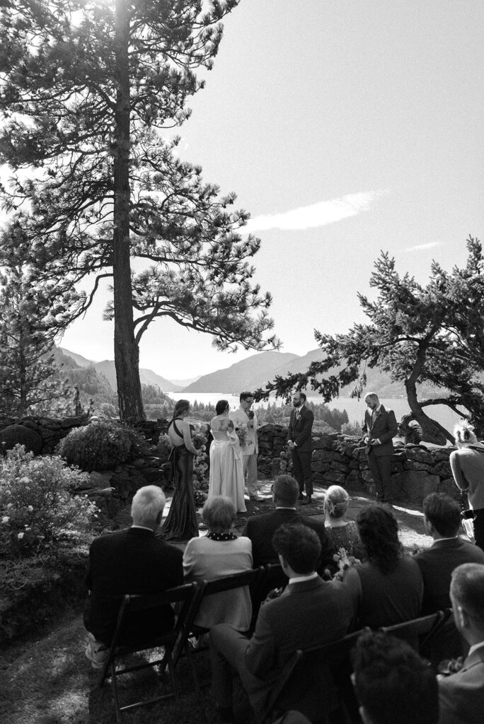 A b+w image depicts a couple exchanging vows at their the griffin house hood river wedding 
