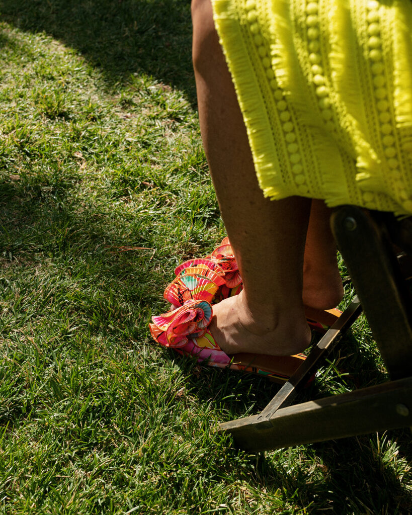 A wedding guest at the griffin house hood river is photographed wearing a bright colored dress & matching shoes 