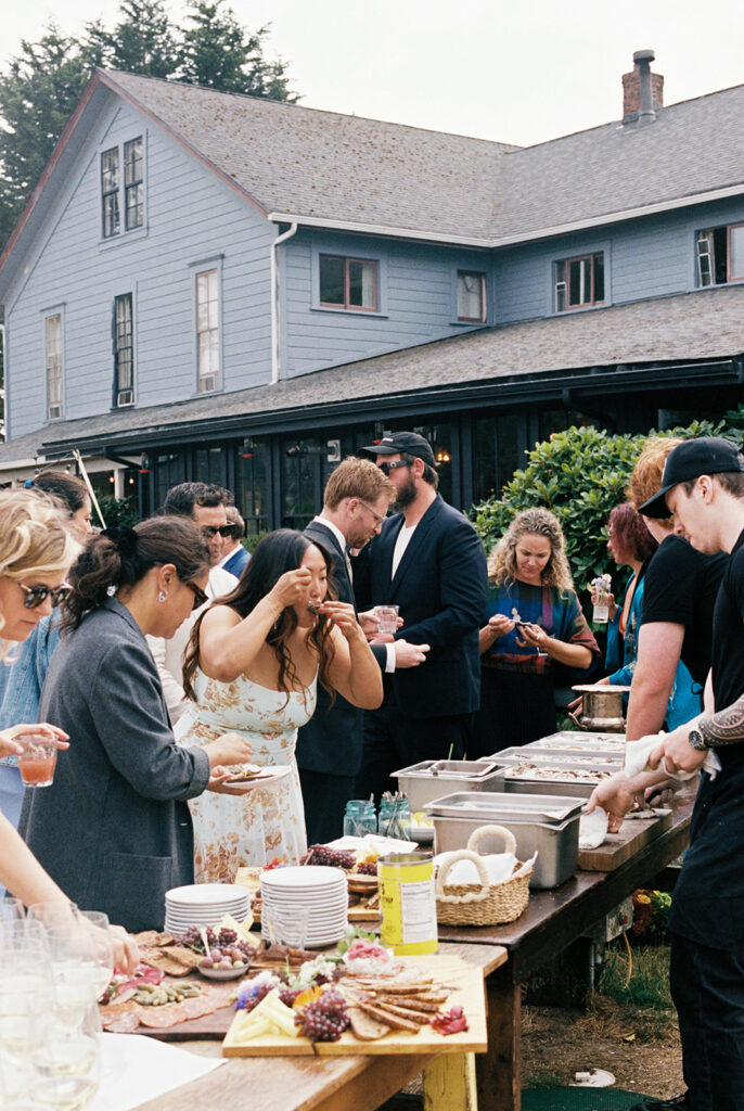Wedding guests at the Tokeland Hotel enjoy the oyster bar at a Tokeland WA wedding reception