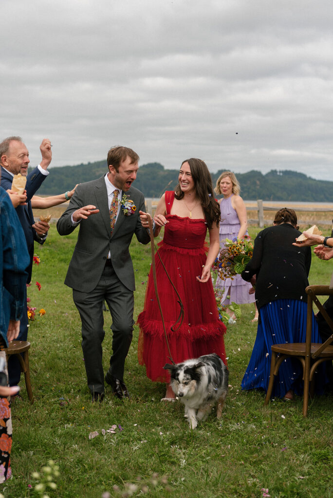 A bride & groom celebrate after their wedding ceremony at The Tokeland Hotel WA