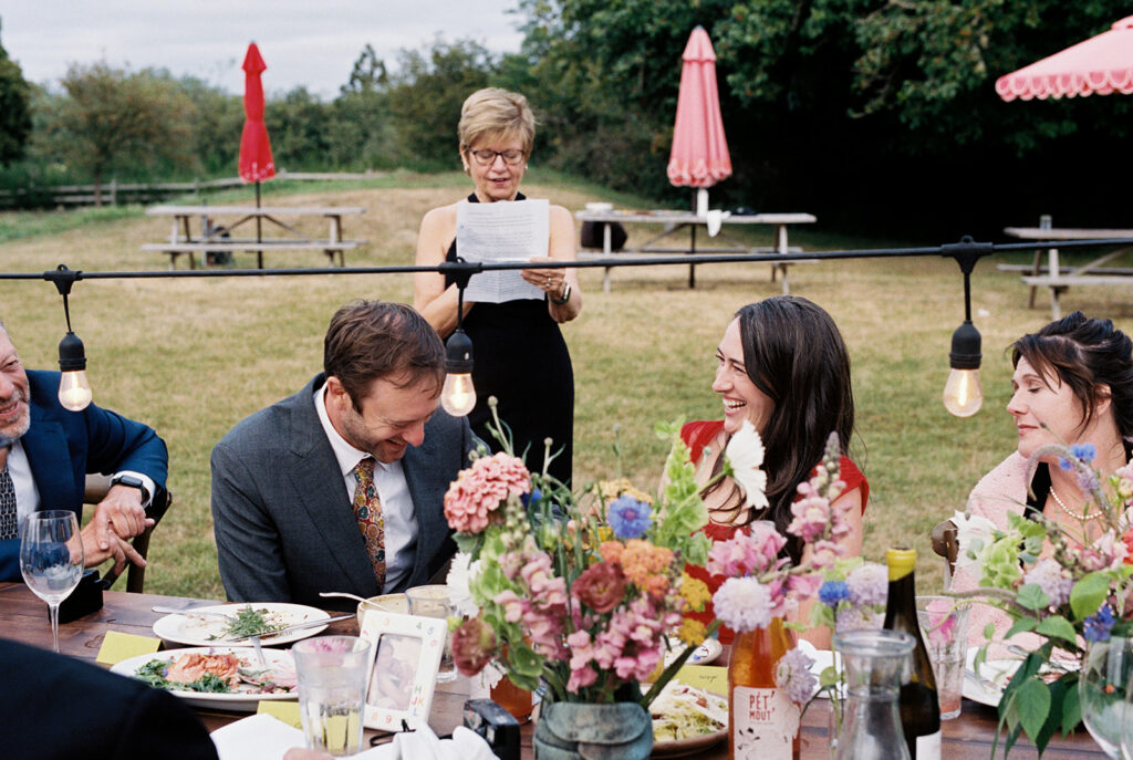 A wedding guest gives a speech at an outdoor reception held at The Tokeland Hotel 