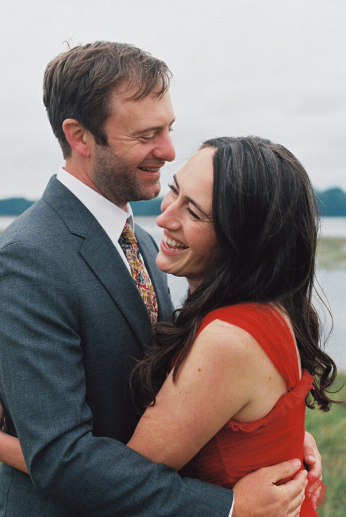 A bride and groom embrace in their wedding attire at their Tokeland Washington wedding