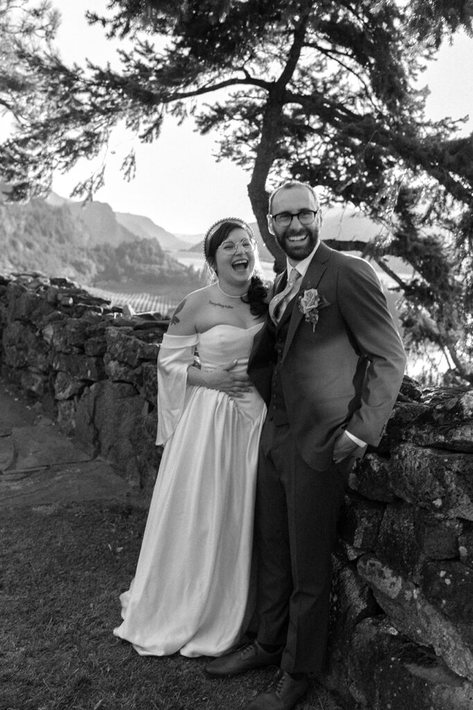 a b+w image depicts smiling newlyweds following their columbia gorge wedding at the griffin house in hood river, or