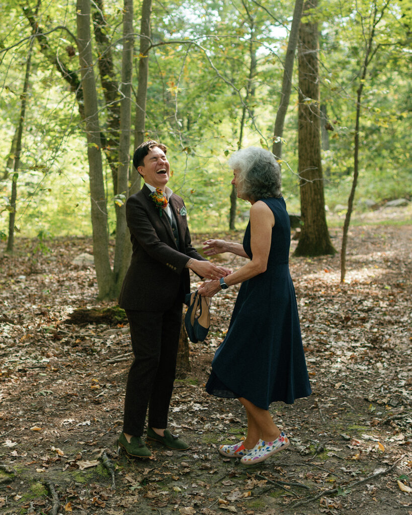A bride and her mother laugh during photos taken at her Westchester County wedding 
