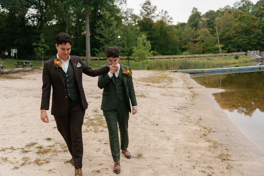 Newlyweds walk along the shore at Sal J. Prezioso Mountain Lakes Park for wedding photos with LGBT wedding photographer, Mossfloor