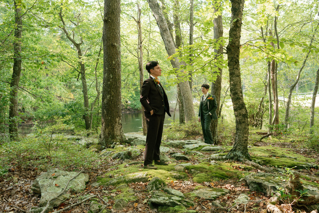 Newlyweds pose for wedding portaits surrounded by moss covered forest floor & trees at mountain lakes park north salem ny 