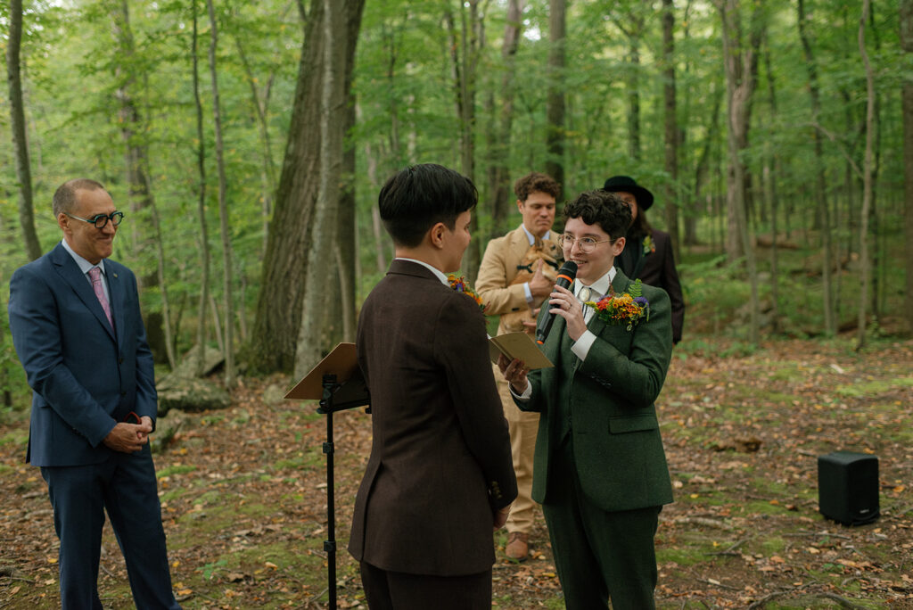 A couple exchanges vows during their heartfelt ceremony in the forest at mountain lakes park