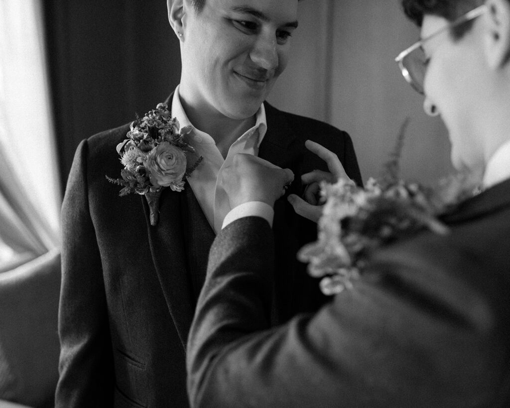 A black and white image depicts two women getting ready for their NY wedding at Sal J. Prezioso Mountain Lakes Park