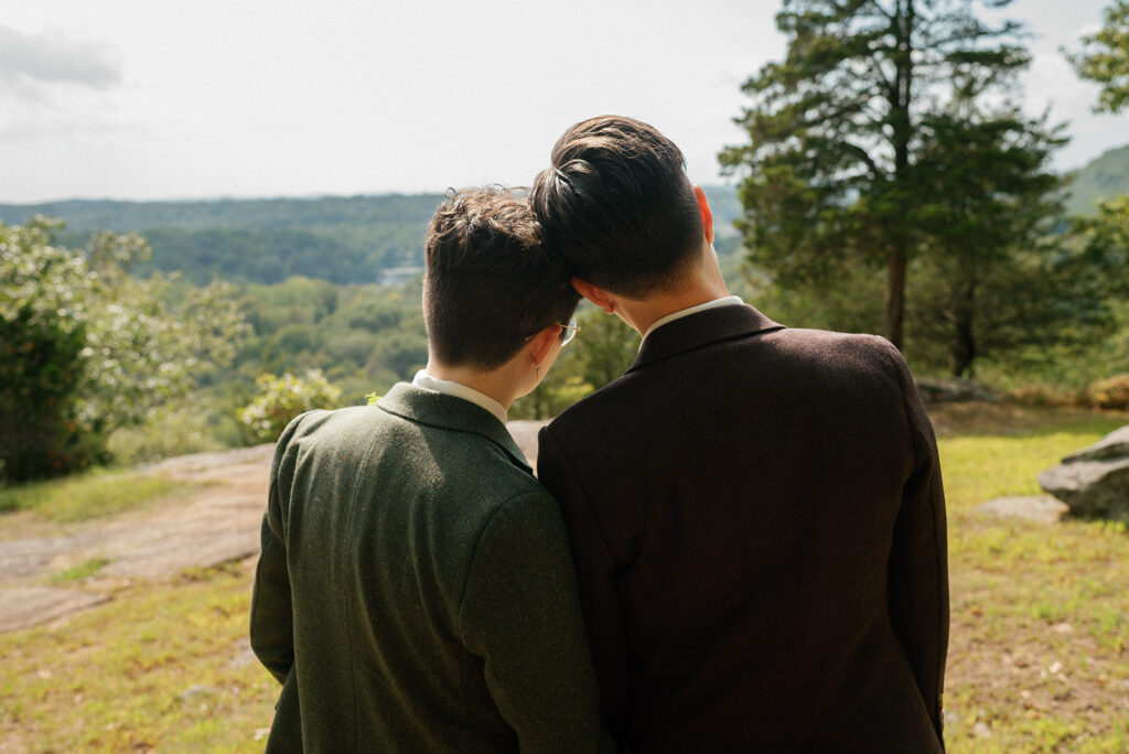 A newlywed couple leans into each other overlooking the scenery at Mountain Lakes Park at their Westchester County Wedding 