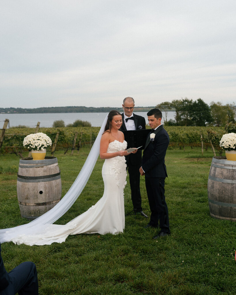 a bride & groom exchange vows at a new england vineyard wedding