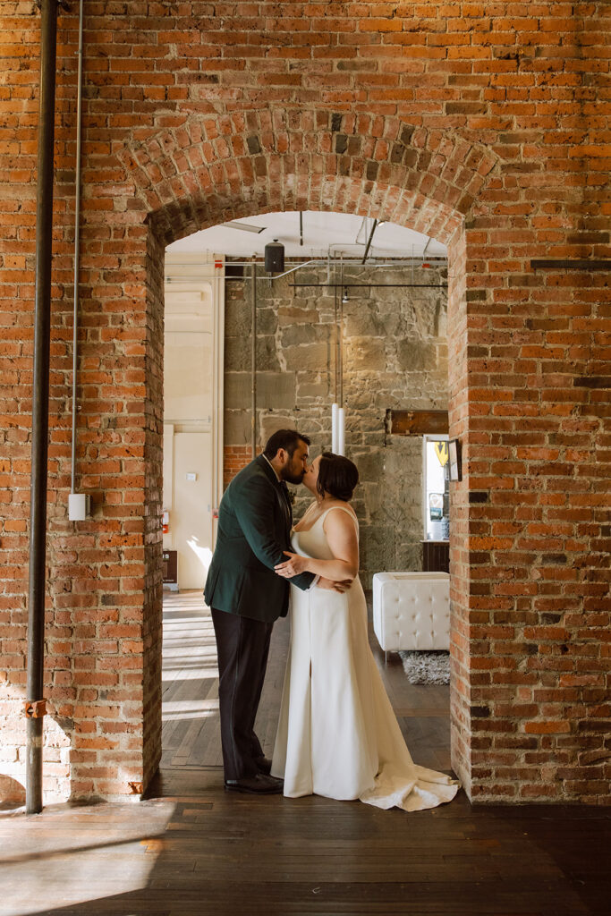 Newlyweds share a kiss at their Seattle wedding reception